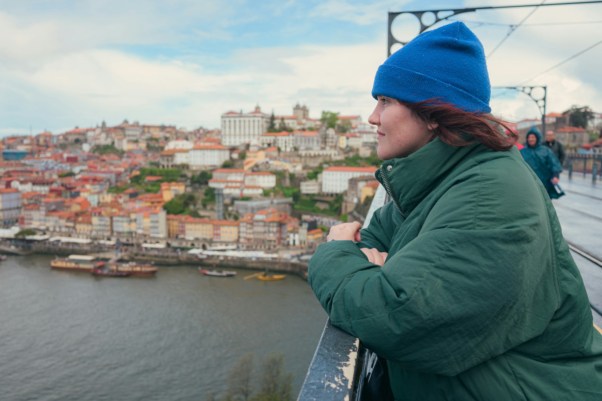 Woman overlooking the picturesque Douro river and colorful cityscape of Porto, Portugal
