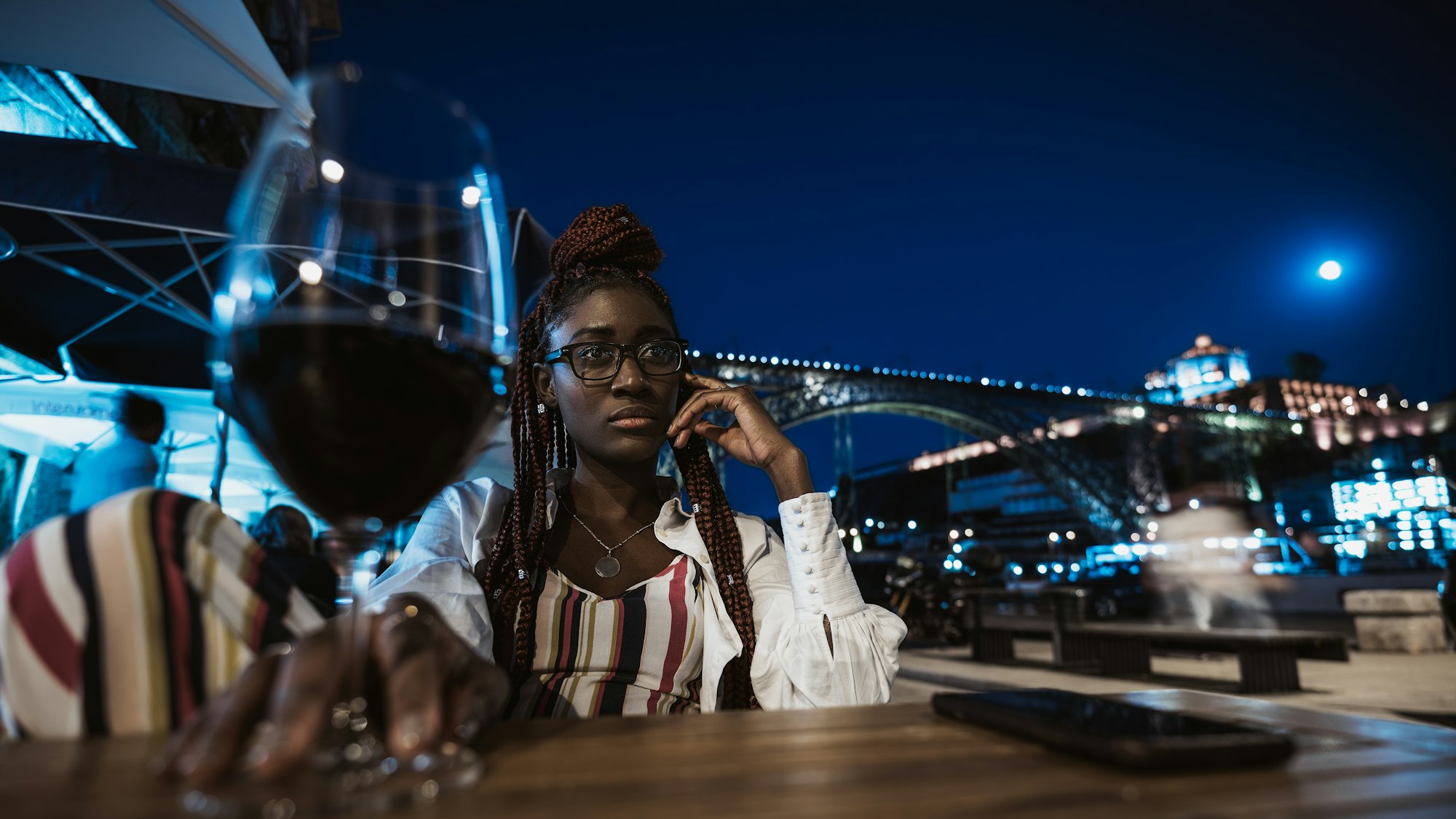 Black girl is chilling in a night street bar